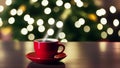 A cup of coffee with candles and a Christmas tree on a wooden table