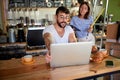 Coffee store.Man working on laptop and woman together Royalty Free Stock Photo