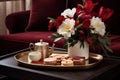 A coffee table adorned with holiday-themed decor, such as a tray of hot cocoa, cookies, and a festive floral arrangement.