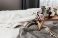 Coffee table on bed. Flowers, coffee cup and candles. Interior gray tones, plaid Royalty Free Stock Photo