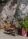 Coffee table and chairs next to old shabby wall on street in Nicosia, Cyprus Royalty Free Stock Photo