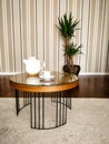 Coffee table with tea cup and teapot, with wooden background and plant, trunk of Brazil