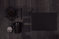 Coffee takeaway set mockup for brand - black paper cup, blank paper, card, label, decoration, coffee beans on dark black wood.