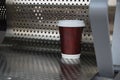 Coffee takeout cup on a silver chair Royalty Free Stock Photo
