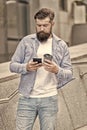 Coffee talk during break. Bearded man hold takeaway cup and smartphone. Enjoying coffee break. Modern life. Smartphone Royalty Free Stock Photo