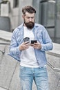 Coffee talk during break. Bearded man hold takeaway cup and smartphone. Enjoying coffee break. Modern life. Smartphone Royalty Free Stock Photo