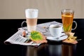 Coffee, tea, latte with dry leaves and newspapers