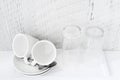 Coffee and tea making set of white cups, saucers, tea spoons and glasses on white porcelain tray. Hotel accomodation. Royalty Free Stock Photo