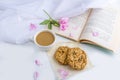 Coffee or tea with milk and oat cookies. Reading old book and snack in spring, summer day in garden. Romantic vintage still life Royalty Free Stock Photo