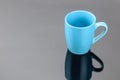 Coffee tea porcelain clay mug on the grey mirror background. Copy space