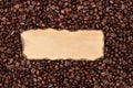 Coffee texture with empty space for text or photos. a burnt piece of paper lies on the brown coffee beans. coffee background for a