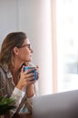 Coffee, thinking and woman in home office with laptop, daydreaming and enjoy peaceful remote work break. Freelance Royalty Free Stock Photo