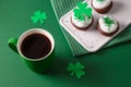 Coffee and three cupcakes for celebration St Patricks Day. Royalty Free Stock Photo