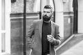 Coffee time. Businessman in hipster style holding takeaway coffee. Hipster with disposable paper cup walking in city Royalty Free Stock Photo