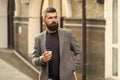 Coffee time. Businessman in hipster style holding takeaway coffee. Hipster with disposable paper cup walking in city Royalty Free Stock Photo