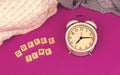 Coffee time morning concept, old vintage alarm clock on purple retro background, knitted sweaters Royalty Free Stock Photo