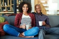 Coffee time is quality time. Portrait of a happy young couple enjoying a relaxing coffee break together on the sofa at Royalty Free Stock Photo