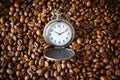 Coffee time. Vintage opened pocket watch among coffee beans. Morning coffee, 10 o`clock. Royalty Free Stock Photo
