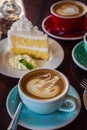 Coffee time in the wood table cafe , drink coffee and tasty cake Royalty Free Stock Photo