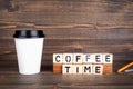 Coffee time, wooden letters on desk. Coffee cup with copy space