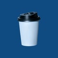 Coffee to go on a blue background isolated. Blank kraft paper cup with black lid, hot drinks take away, shop, cafe menu Royalty Free Stock Photo