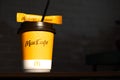 Coffee to go of McDonald`s with the inscription Maccafe in Russian stick with sugar on the table with a napkin and a straw. Fast Royalty Free Stock Photo