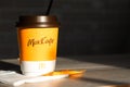 Coffee to go of McDonald`s with the inscription Maccafe in Russian stick with sugar on the table with a napkin and a straw. Fast Royalty Free Stock Photo