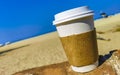 Coffee to go mug on the beach sand sea waves Royalty Free Stock Photo