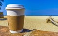 Coffee to go mug on the beach sand sea waves Royalty Free Stock Photo