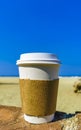 Coffee to go mug on the beach sand sea waves Royalty Free Stock Photo