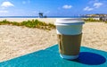 Coffee to go mug on the beach sand sea waves Royalty Free Stock Photo