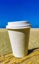 Coffee to go mug on the beach sand sea waves Royalty Free Stock Photo