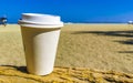 Coffee to go mug on the beach sand sea waves Royalty Free Stock Photo