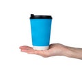 Coffee to go. A woman's hand with blue paper cup isolated on white background. Close-up. Selective focus Royalty Free Stock Photo