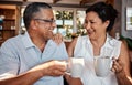 Coffee, toast and senior couple laughing in home, having fun and bonding. Love, tea cheers and smile of happy, retired Royalty Free Stock Photo