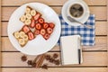 Coffee and toast with strawberries and bananas . notepad and pen Royalty Free Stock Photo