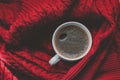 Coffee top view. black coffee in a white mug on Red Sweater background. winter time concept. Royalty Free Stock Photo