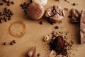 Coffee trace and roasted beans,ground coffee on spoon, macarons, chocolate, cinnamon on brown background. Coffee moody image