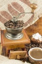 Coffee in various forms around vintage coffee grinder Royalty Free Stock Photo
