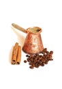 Coffee in vintage copper turkish coffee pot (cezve or ibrik) , coffee beans and cinnamon sticks on white Royalty Free Stock Photo