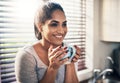 Coffee is where good vibes come from. Cropped shot of a beautiful young woman,enjoying a cup of coffee at home. Royalty Free Stock Photo