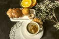 Coffee in white cup dishes with cakes,saucer with orange slices Royalty Free Stock Photo