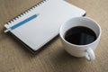 Coffee in white cup with Journal book and pencil Royalty Free Stock Photo