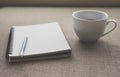 Coffee in white cup with Journal book and pencil Royalty Free Stock Photo