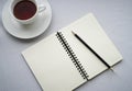 Coffee in white cup with Journal book and pencil Royalty Free Stock Photo