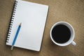 Coffee in white cup with Journal book and pencil Royalty Free Stock Photo