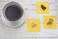 Coffee with white cup and mixed nuts on white table.