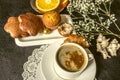 Coffee in white cup and saucer dishes with cakes and chocolate