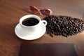 Coffee in white cup and a seed,book,Eyeglasses is placed nearby. Royalty Free Stock Photo