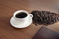 Coffee in white cup and a seed is placed nearby. Royalty Free Stock Photo